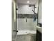 Modern shower with glass doors, white subway tile, and black fixtures at 305 Briarcliff Dr, Dunn, NC 28334
