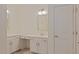 Functional bathroom featuring a vanity with sink, storage cabinets, mirrors, and a door leading to another room at 317 Springhurst Ln, Cary, NC 27511