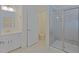 Bright bathroom featuring a standalone shower, toilet, vanity with sink, and tile floors at 317 Springhurst Ln, Cary, NC 27511