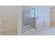 Bright bathroom showcasing a modern shower with glass doors and a soaking tub at 317 Springhurst Ln, Cary, NC 27511