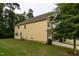Exterior view of home and green lawn, complemented by a side-entry garage and mature trees at 317 Springhurst Ln, Cary, NC 27511