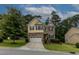 Traditional two-story home with brick accents, a two-car garage, and a well-kept front lawn at 317 Springhurst Ln, Cary, NC 27511
