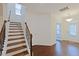Foyer with hardwood flooring, staircase, and an open view into the office area at 317 Springhurst Ln, Cary, NC 27511