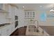 Modern kitchen features stainless steel appliances, granite counters, and an island with a double sink at 317 Springhurst Ln, Cary, NC 27511