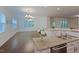 Open concept kitchen with an island, granite counters, and view into living area with hardwood floors at 317 Springhurst Ln, Cary, NC 27511