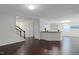 Open-concept living room and kitchen area featuring hardwood floors and neutral paint colors at 317 Springhurst Ln, Cary, NC 27511
