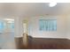 Open living room area with hardwood floors and a large window for natural light at 317 Springhurst Ln, Cary, NC 27511