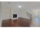 Open-concept living room with fireplace and hardwood floors, showing staircase to second story at 317 Springhurst Ln, Cary, NC 27511