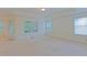 Spacious main bedroom featuring tray ceilings, plush carpet, and plenty of natural light through multiple windows at 317 Springhurst Ln, Cary, NC 27511