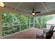 Relaxing screened-in porch with wooden floors, a ceiling fan, and views of the green backyard at 317 Springhurst Ln, Cary, NC 27511
