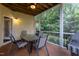 Cozy screened porch with a dining table, ceiling fan, and peaceful backyard view at 317 Springhurst Ln, Cary, NC 27511