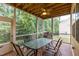 Covered screened porch with dining table and ceiling fan, perfect for outdoor dining at 317 Springhurst Ln, Cary, NC 27511