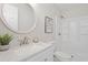 This bathroom has a speckled white vanity, a round mirror, and a shower at 3204 Winfield Ct, Raleigh, NC 27610