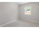 This bedroom features light gray walls, light carpet, and one window at 3204 Winfield Ct, Raleigh, NC 27610