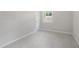 This bedroom features light gray walls, light carpet, and a window at 3204 Winfield Ct, Raleigh, NC 27610
