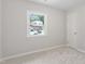 This bedroom features light gray walls, light carpet, and a window at 3204 Winfield Ct, Raleigh, NC 27610