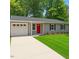 Charming single-story home featuring a red front door, attached garage, and well-maintained lawn at 3204 Winfield Ct, Raleigh, NC 27610