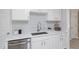 Modern kitchen features stainless steel dishwasher, quartz countertops, and subway tile backsplash at 3204 Winfield Ct, Raleigh, NC 27610