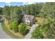 Aerial shot of home surrounded by mature trees and lush landscaping at 344 Colonial Ridge Dr, Pittsboro, NC 27312