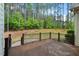 Outdoor deck with black metal railing overlooking wooded backyard at 344 Colonial Ridge Dr, Pittsboro, NC 27312