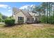 A view of the backyard with a deck, patio and lush greenery at 344 Colonial Ridge Dr, Pittsboro, NC 27312