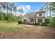 Backyard view of the house showing deck, patio and treeline at 344 Colonial Ridge Dr, Pittsboro, NC 27312