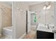Bathroom with double vanity sinks, bathtub, and a view into an adjacent bedroom at 344 Colonial Ridge Dr, Pittsboro, NC 27312
