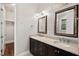 Bathroom with dual sink vanity, framed mirrors, and walk-in closet at 344 Colonial Ridge Dr, Pittsboro, NC 27312