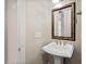 Powder room with pedestal sink, decorative mirror, and light fixture at 344 Colonial Ridge Dr, Pittsboro, NC 27312