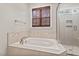 Bathroom with a soaking tub and glass-enclosed shower at 344 Colonial Ridge Dr, Pittsboro, NC 27312