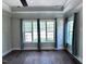 Bright bedroom featuring hardwood floors, large windows, and tray ceilings at 344 Colonial Ridge Dr, Pittsboro, NC 27312