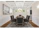 Elegant dining room with coffered ceiling, modern chandelier, and wainscoting at 344 Colonial Ridge Dr, Pittsboro, NC 27312