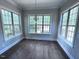 Bright dining room with hardwood floors, large windows, and stylish chandelier at 344 Colonial Ridge Dr, Pittsboro, NC 27312