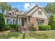 Charming home featuring a stone facade, landscaped front yard, and inviting front porch at 344 Colonial Ridge Dr, Pittsboro, NC 27312