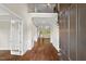 Welcoming foyer featuring hardwood floors, wainscoting, staircase, and light-filled spaces at 344 Colonial Ridge Dr, Pittsboro, NC 27312