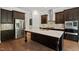 Modern kitchen featuring a large island, stainless steel appliances, and dark wood cabinets at 344 Colonial Ridge Dr, Pittsboro, NC 27312
