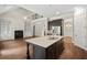 An open kitchen and living room design with a fireplace and lots of natural light at 344 Colonial Ridge Dr, Pittsboro, NC 27312