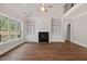 Bright living room featuring built-in shelving, a fireplace and natural light from the large windows at 344 Colonial Ridge Dr, Pittsboro, NC 27312