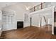 Spacious living room featuring hardwood floors, fireplace, built-in shelving, and natural light at 344 Colonial Ridge Dr, Pittsboro, NC 27312