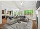 Inviting living room with an open floor plan, seamlessly connected to a kitchen and a sunlit dining area at 344 Colonial Ridge Dr, Pittsboro, NC 27312