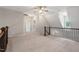 Upstairs loft space with carpet and decorative metal stair railing at 344 Colonial Ridge Dr, Pittsboro, NC 27312