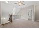 Upstairs loft space with carpet and decorative metal stair railing at 344 Colonial Ridge Dr, Pittsboro, NC 27312