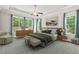 Spacious main bedroom with large windows, tray ceilings, and stylish decor at 344 Colonial Ridge Dr, Pittsboro, NC 27312