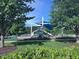 Beautiful community playground with several slides, swings, and a climbing structure, surrounded by lush landscaping at 344 Colonial Ridge Dr, Pittsboro, NC 27312