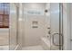 Walk-in shower with glass enclosure, bench seat and tiled walls at 344 Colonial Ridge Dr, Pittsboro, NC 27312