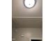 Attic access panel on the ceiling with a circular ceiling light at 352 Riverstone Dr, Clayton, NC 27527