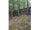 Fenced backyard surrounded by mature trees offering privacy and a natural setting at 352 Riverstone Dr, Clayton, NC 27527