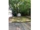 Spacious backyard featuring a shed and bordering lush greenery, providing privacy at 352 Riverstone Dr, Clayton, NC 27527