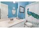 Bright bathroom featuring blue walls, a peacock shower curtain, and modern fixtures at 352 Riverstone Dr, Clayton, NC 27527