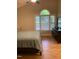 Bedroom with ensuite bathroom, a dresser, and a large window overlooking a landscaped yard at 352 Riverstone Dr, Clayton, NC 27527